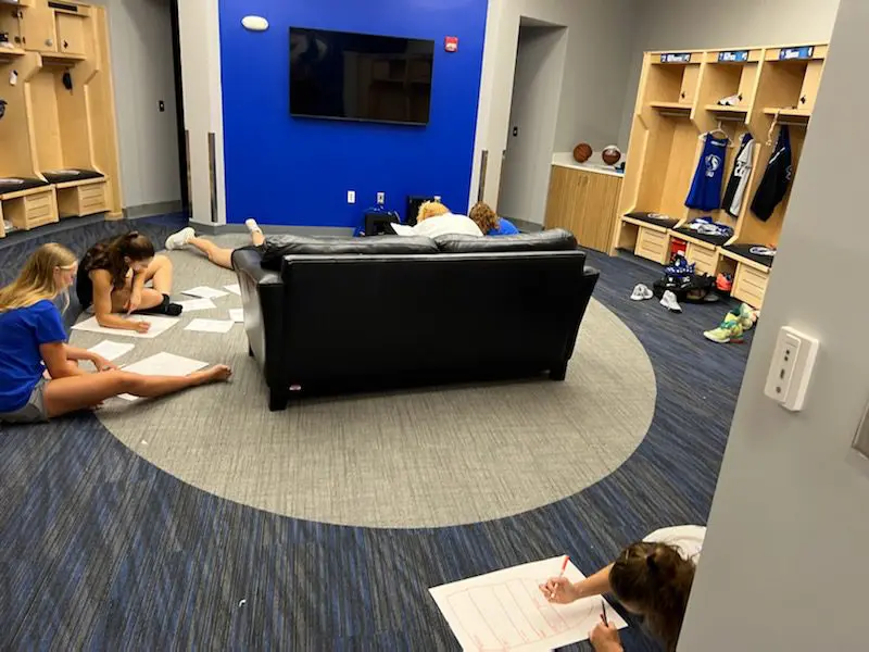 People studying in a locker room lounge.
