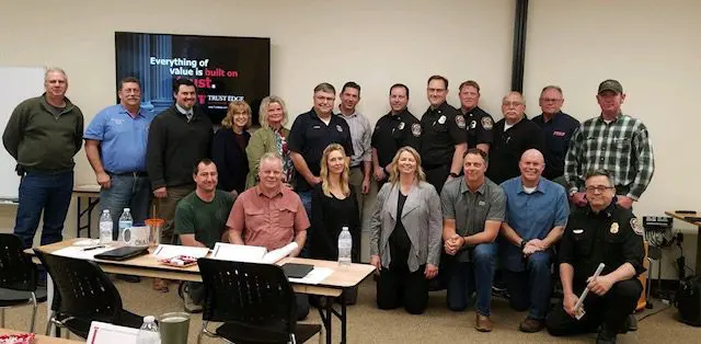 Group photo of people in a meeting.