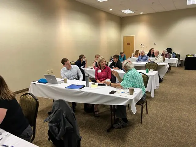 People attending a conference in a room.