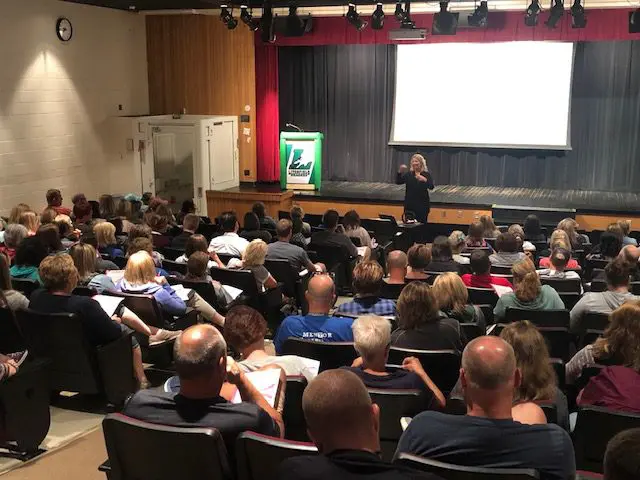 Audience attending a presentation in a hall.