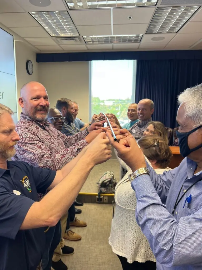 People forming a circle with their fingers.