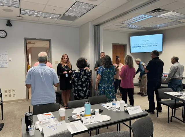 People gathered in a meeting room discussion.