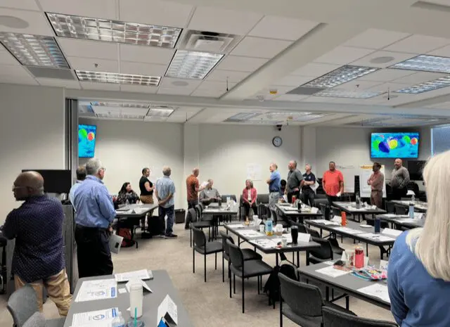 People gathered in a conference room setting.