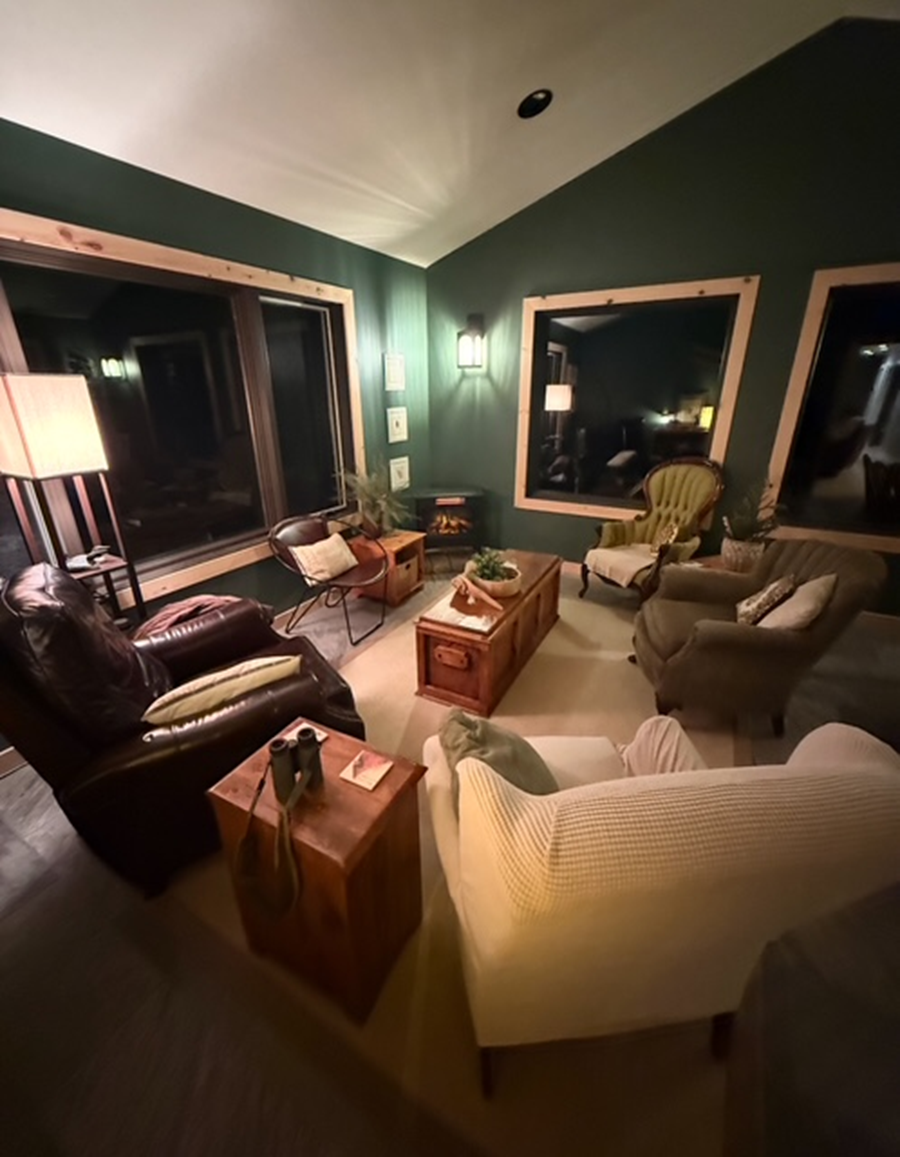Cozy living room with leather and fabric chairs around a central ottoman.