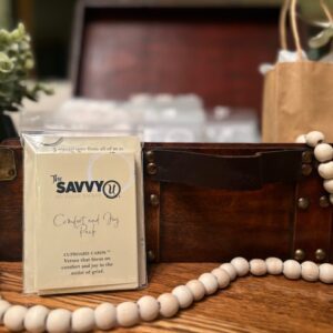 A wooden table with a bag and some beads