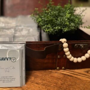 A wooden box with a white bead necklace on it.