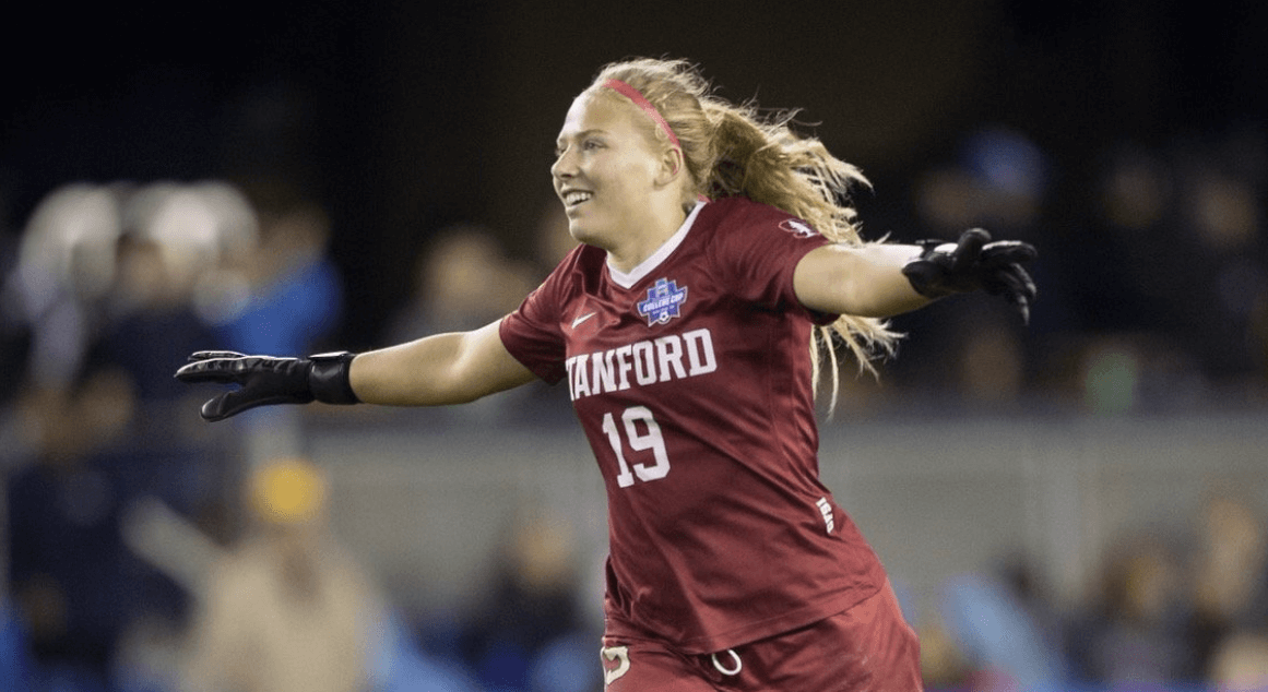 A woman in red shirt playing soccer on field. A woman in red shirt playing soccer on field.